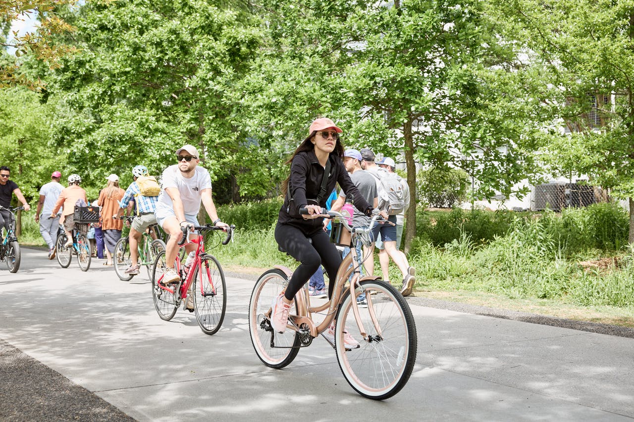 A cyclist passes by Historic Fourth Ward Skatepark on a busy spring day. Photo by Erin Sintos.