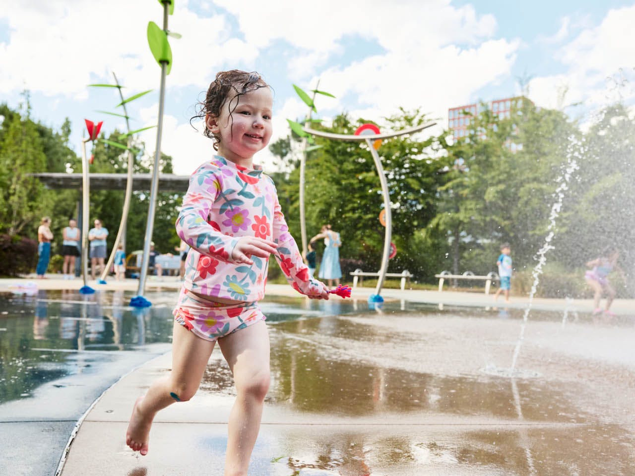 A toddler runs through the splash pad at Historic Fourth Ward Park. (Photo Credit: Erin Sintos)