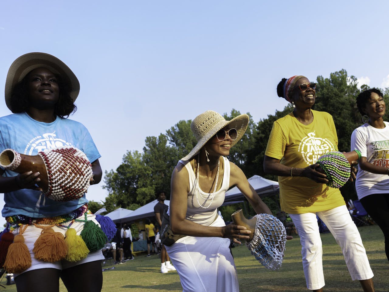 People stand with musical instruments.