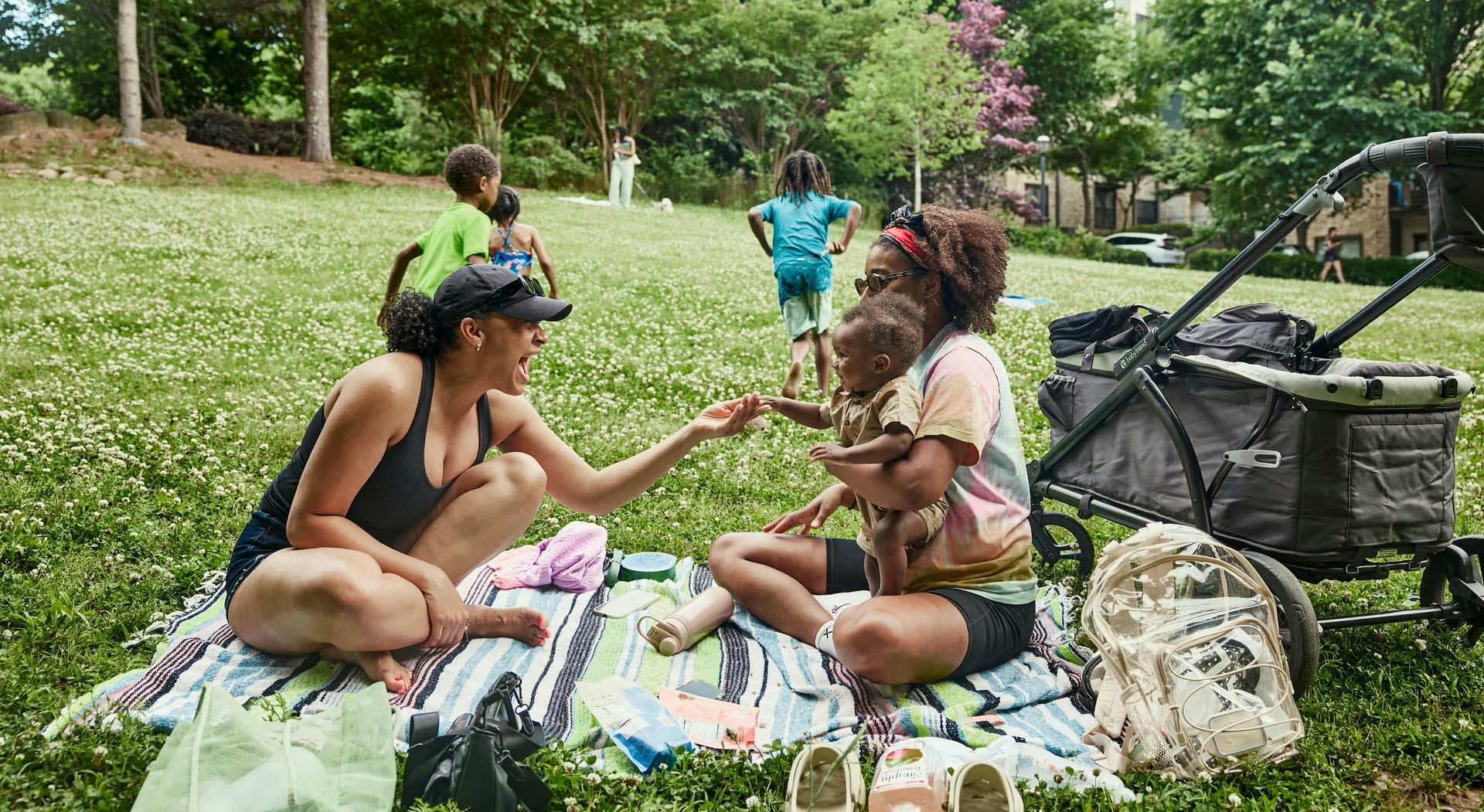 A family picnics on the grass at Historic Fourth Ward Park. (Photo Credit: Erin Sintos)