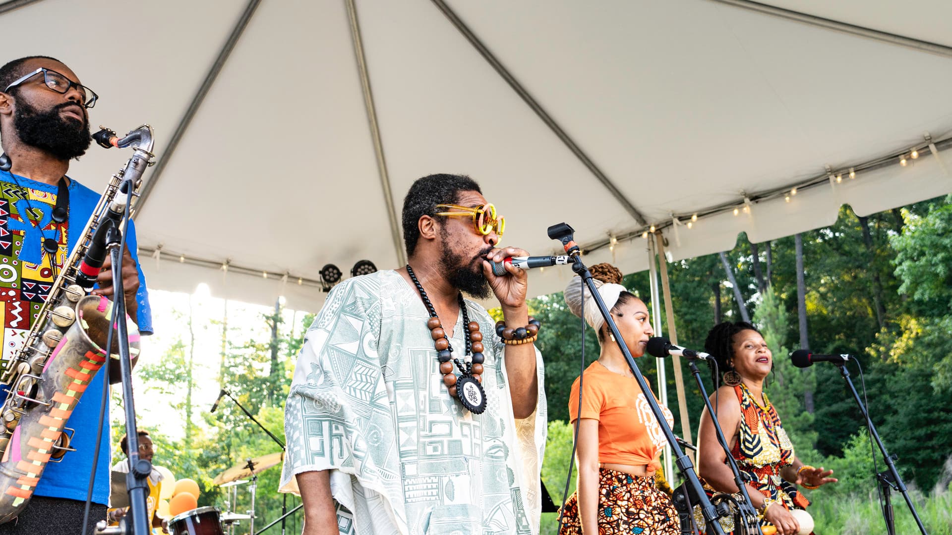 Musicians perform in front of a crowd.