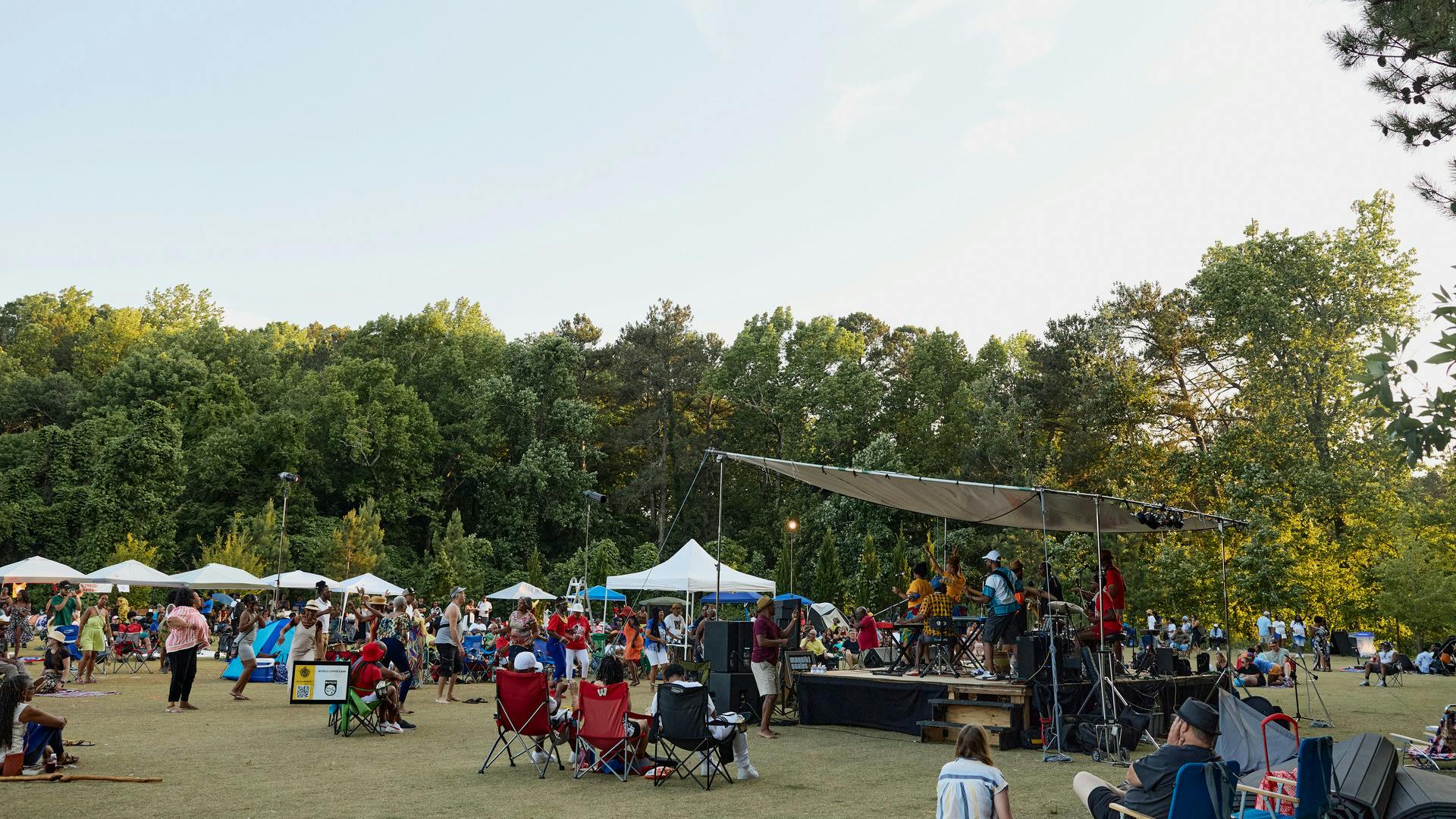 People sit in front of a stage that has live performers.